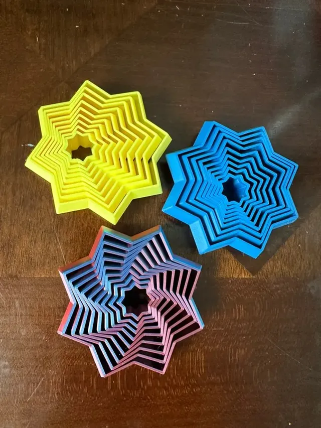 3D printed folding fidget star that collapses flat and blooms into a ninja-star shape