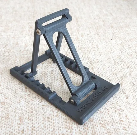 Adjustable folding 3D printed phone stand holding a smartphone upright